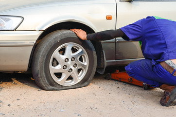 Flat tire on car with technician