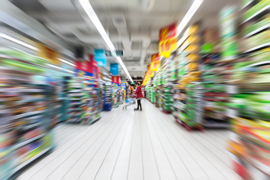 Young woman shopping in the supermarket,motion blur