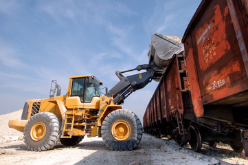 excavator loads gravel