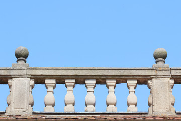 Old stone balustrade with blue sky in the background