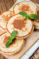 Freshly made fritters with mint leaves, vertical shot