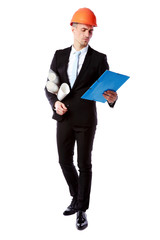 Confident businessman in helmet reading construction plan