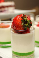 Panacotta dessert with strawberry on the top.