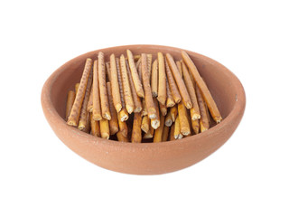 Salted sticks in clay plate isolated over white