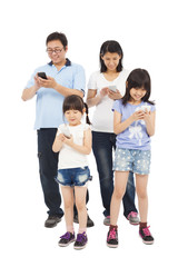 Obraz premium Happy Family standing and using smart phone together