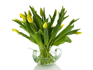 glass teapot with yellow tulips