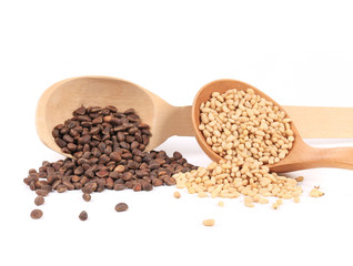 Wooden spoons full with pine nuts.