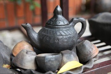 Ancient clay teapot and teacups