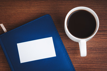 Notepad, calling card and coffee cup