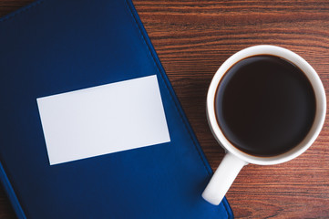 Obraz na płótnie Canvas Notepad, calling card and coffee cup