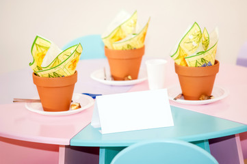 White invitation on colored table