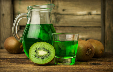 green drink in a glass jug with fresh kiwi