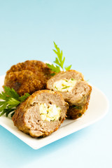 Meat roulade stuffed with cheese, egg and herbs