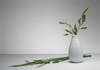 Green field straws in flowerpot