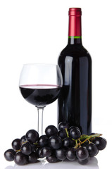 Bottle and glass of wine with black grapes