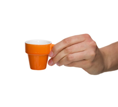 Female Hand holding an Orange Coffee Cup. White Background