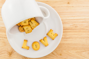 Love - coffee cup with letter cracker