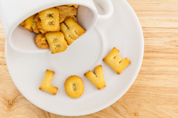 Love - coffee cup with letter cracker