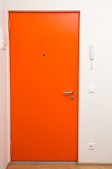 apartment orange door over white wall