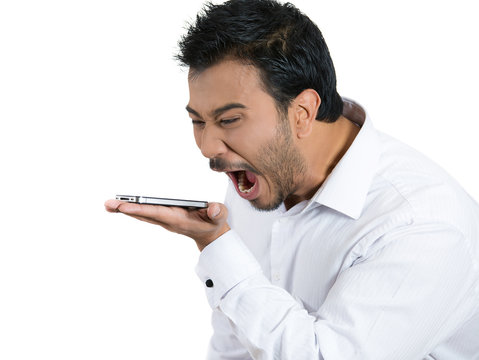 Angry man screaming on cellphone, white background 