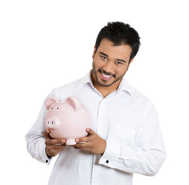 Happy savings. Excited man holding piggy bank, white background 