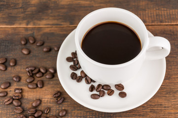 coffee cup with coffee bean on wooden background