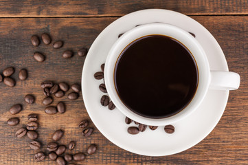 coffee cup with coffee bean on wooden background