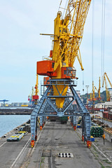 Port cargo crane over blue sky background