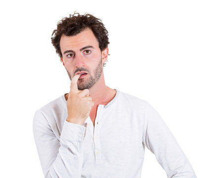 Portrait confused young man looking clueless on white background