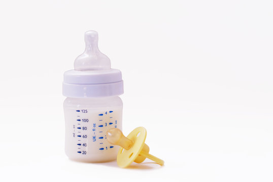 Baby bottle with milk and silicone pacifier