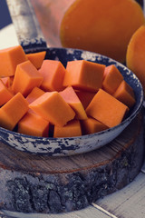 Raw pumpkin on wooden background.