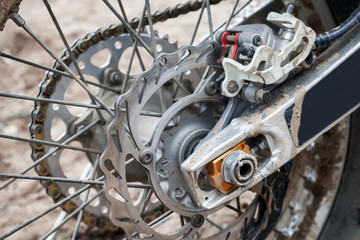 Fototapeta na wymiar Closeup fragment of rear sport motocross bike wheel with brake