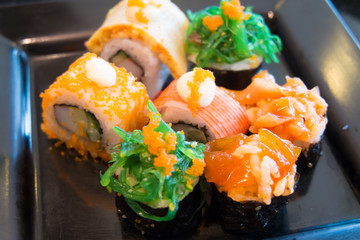 Close up of variety sushi on Black Dish