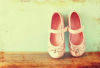 girl shoes over wooden deck floor