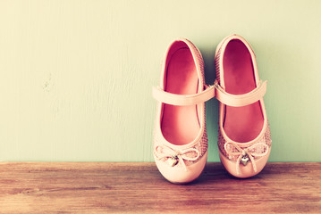 girl shoes over wooden deck floor