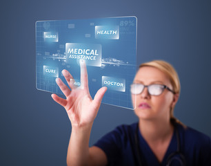 Young nurse pressing modern medical type of buttons
