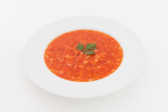 Bowl of tomato soup on a white background