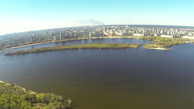 Flight over  big river  and city. Aerial panorama