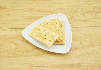 Square crackers in a white plate