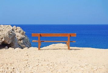 Lonely bench at the seashore