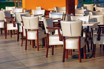 Street cafe with white soft seat cushion chairs