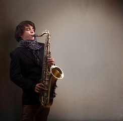 Obraz na płótnie Canvas Young musician playing on saxophone