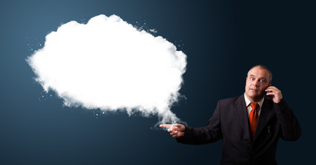 Businessman making phone call and presenting abstract cloud copy