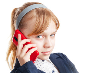 Blond Caucasian schoolgirl calling by mobile phone. Portrait iso