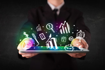 Young person holding tablet with graph and chart symbols