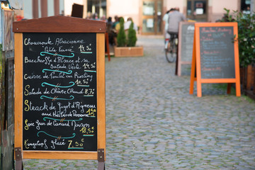 Menu stand with local specialties on Strasbourg street