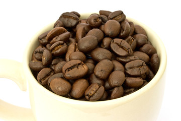 Coffee cup with coffee beans on white