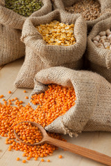 hessian bags with red lentils, peas, chick peas, wheat and green © chamillew