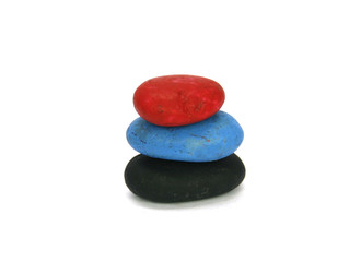 Stack of colored pebble stones on white background