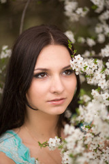 Girl in flowers of cherry